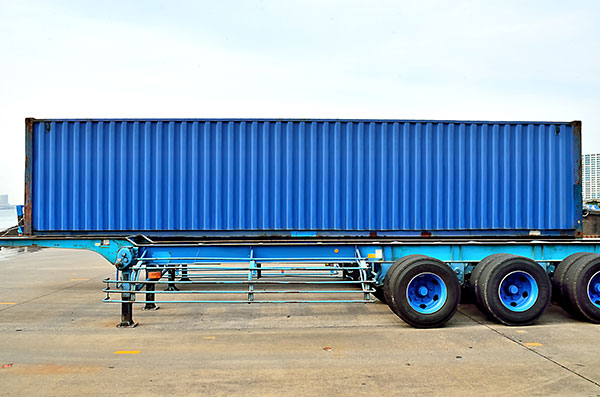 A blue chassis with a blue container sitting on top of it. 