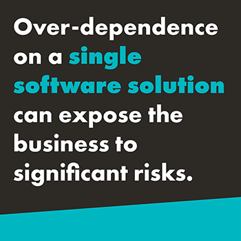 A graphic that reads, "Over-dependence on a single software solution can expose the business to significant risks." The text is in white except for "single software solution" that is bolded and in teal. The background is black with a teal diagonal slash at the bottom of the image.