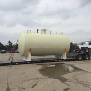 Large horizontal industrial tank secured to a flatbed trailer, representing oversized freight transportation supported by Trinity Logistics Sartell, a Minnesota 3PL.