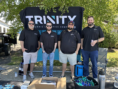Trinity Logistics Team Members at an automotive event supporting customers with auto transportation solutions.
